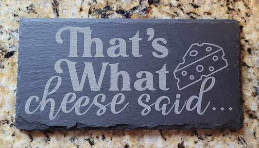 Slate sign with 'That's What Cheese Said' text on a granite countertop