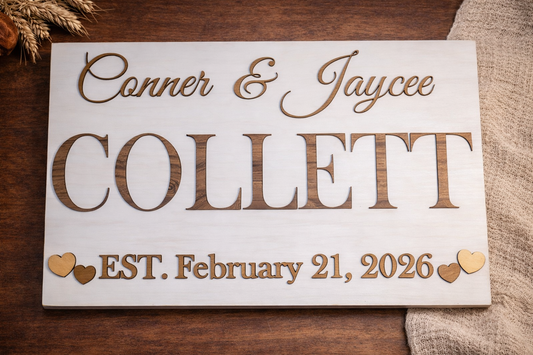 Wooden plaque with engraved names and establishment date on a wooden surface